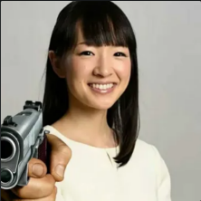 An image of Marie Kondo, a hand holding a pistol has been photoshopped in, pointing towards the viewer